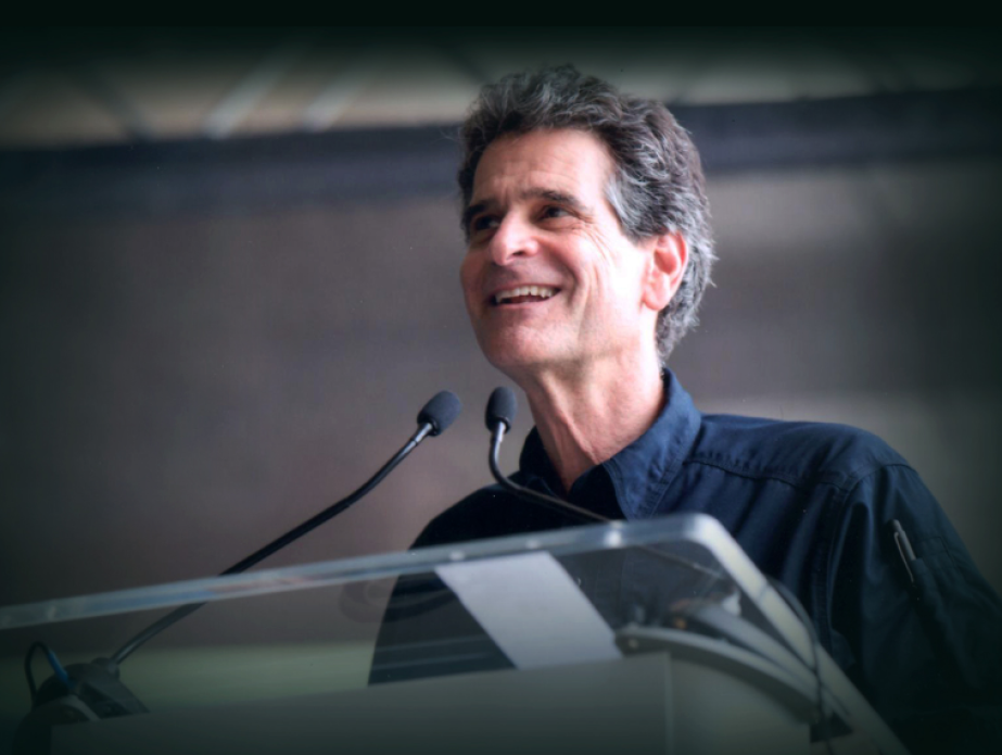 Dean Kamen standing at a podium